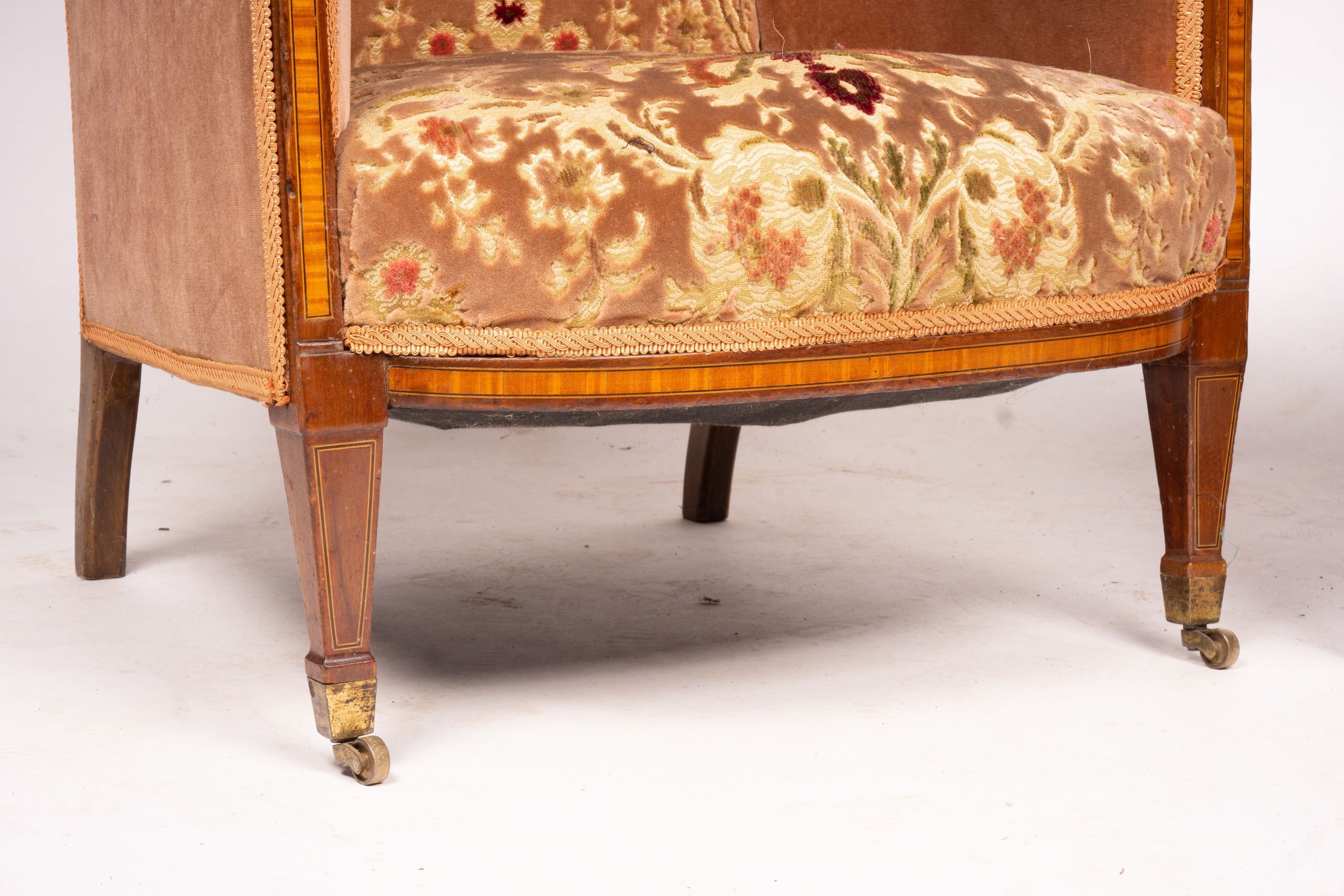 A pair of Edwardian satinwood banded mahogany wing armchairs, width 56cm, depth 75cm, height 110cm